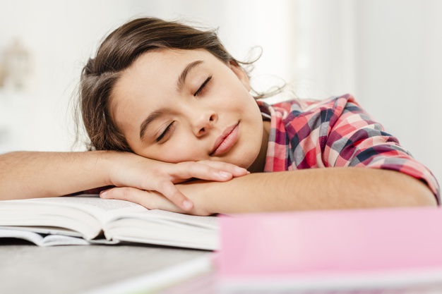 front-view-girl-sleeping-book_23-2148355247